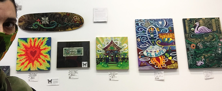 Drea with her art at The Higher Consciousness